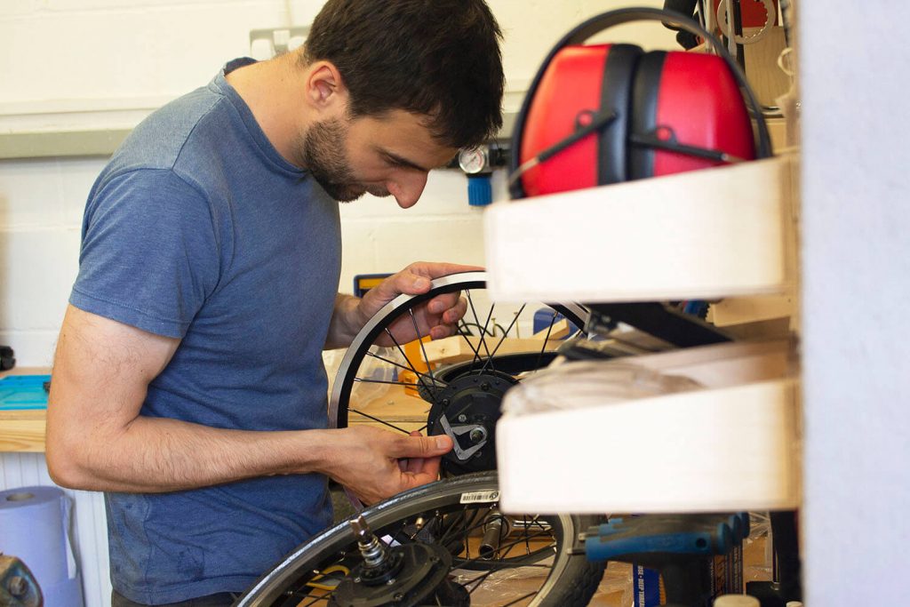 Flit lightweight folding ebikes - engineer servicing bike