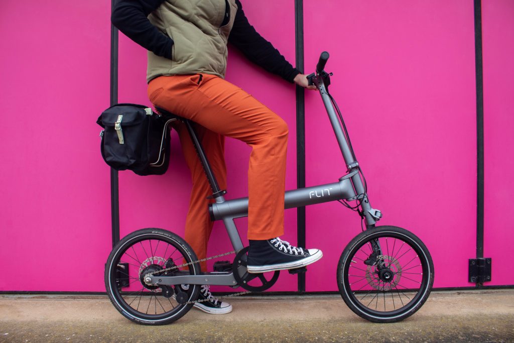Rider with luggage options on a pink background